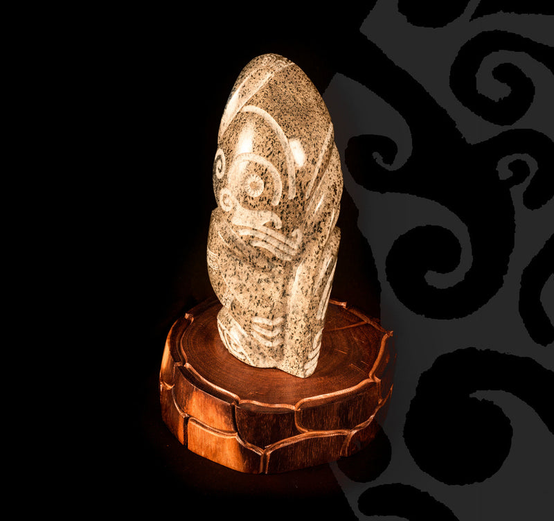 Tiki Sculpted in Stone on a Wooden Pedestal